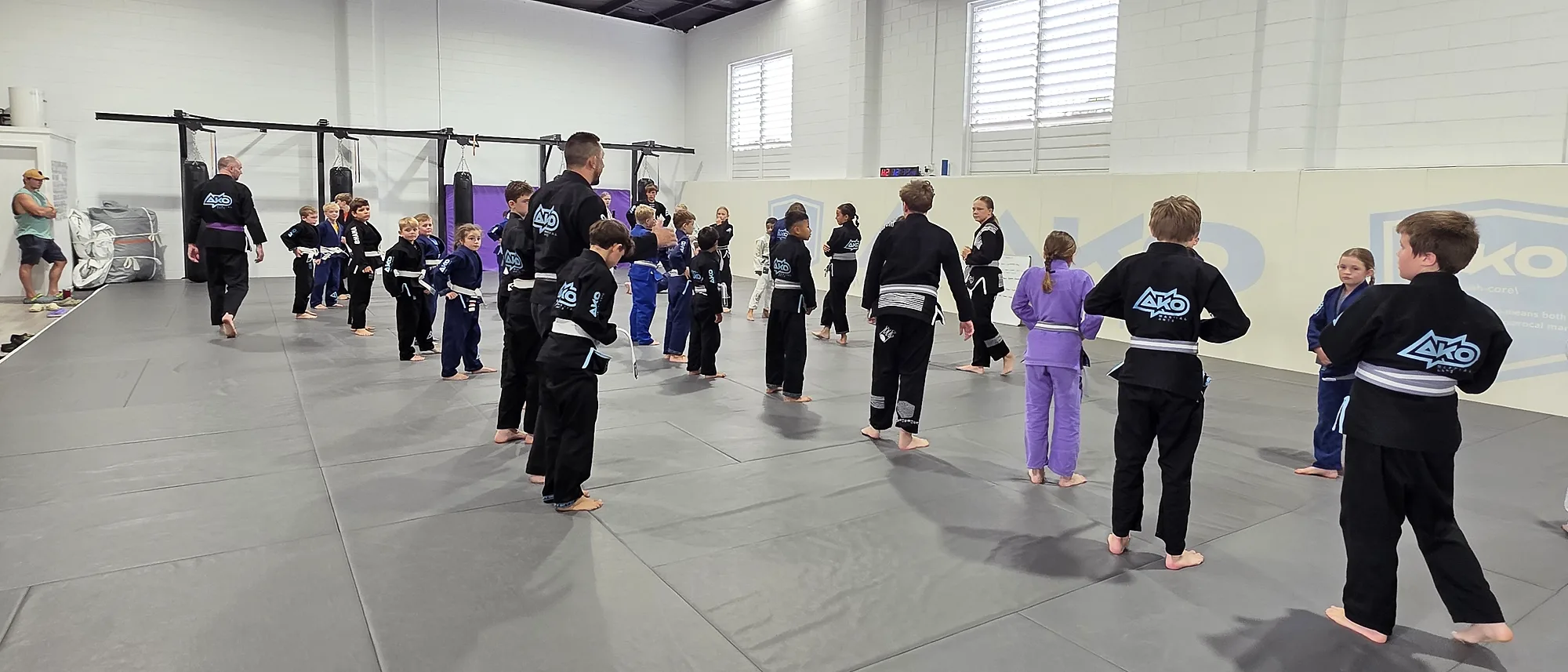 A junior class lined up on the mats at Ako Martial Arts grading day in Sandgate