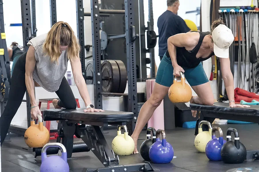 Adults training with kettlebells in a strength and conditioning class