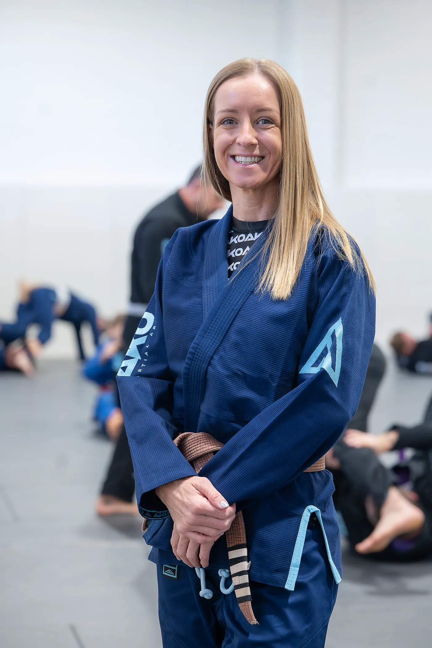 Linzi, a brown belt coach, smiling after training at Ako Martial Arts